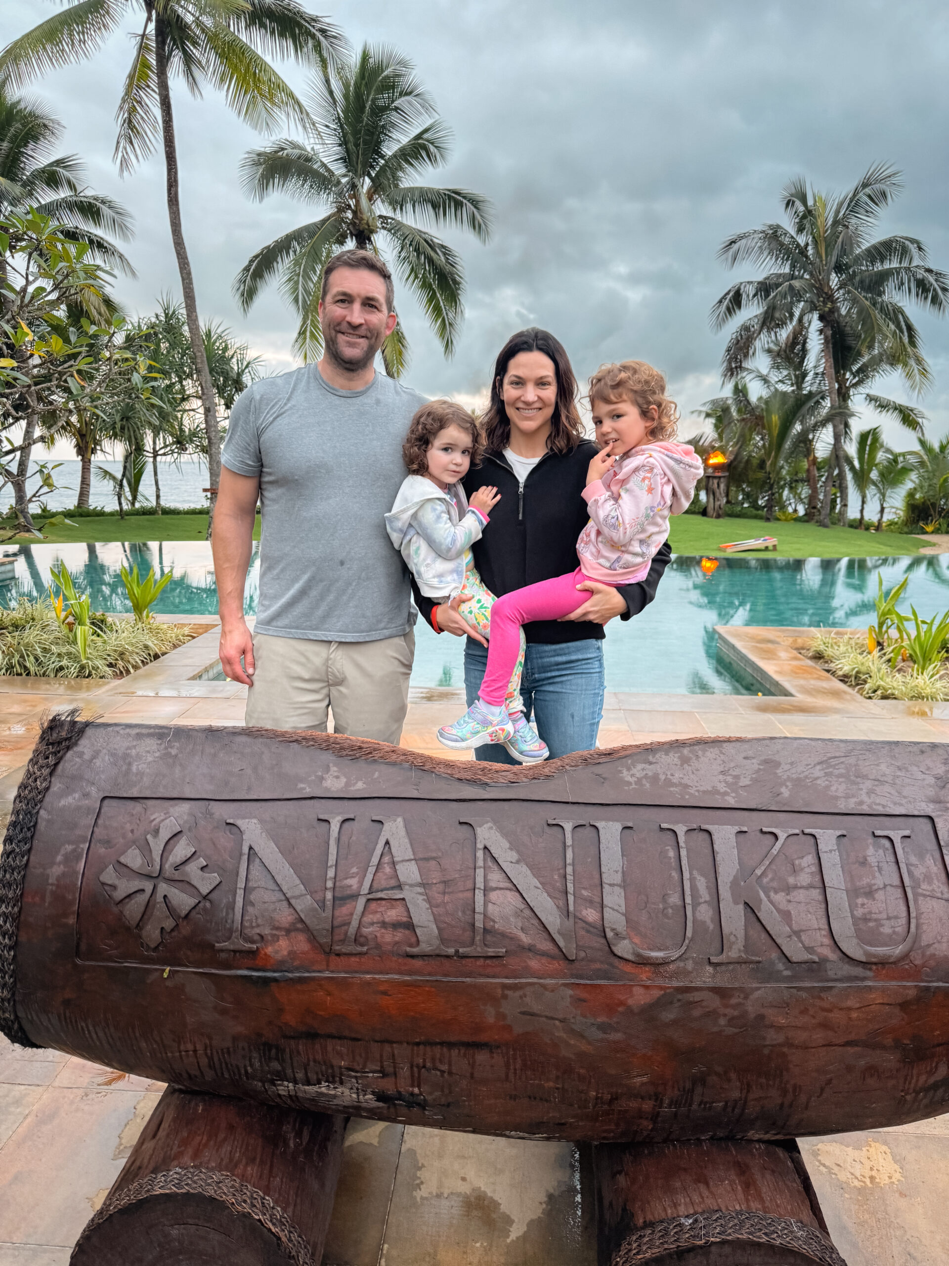 Family enjoying a luxurious getaway at Nanuku Resort in Fiji, a stay that could be booked nearly free using credit card points and miles for an unforgettable vacation. Photo by Amy Berrian.