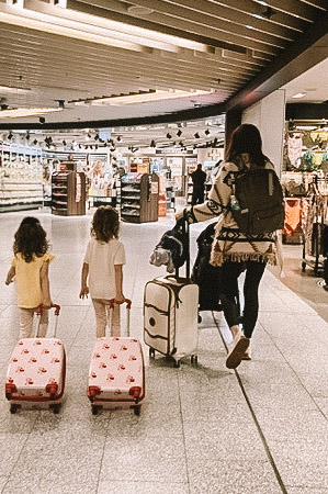 Mom and kids traveling through airport.