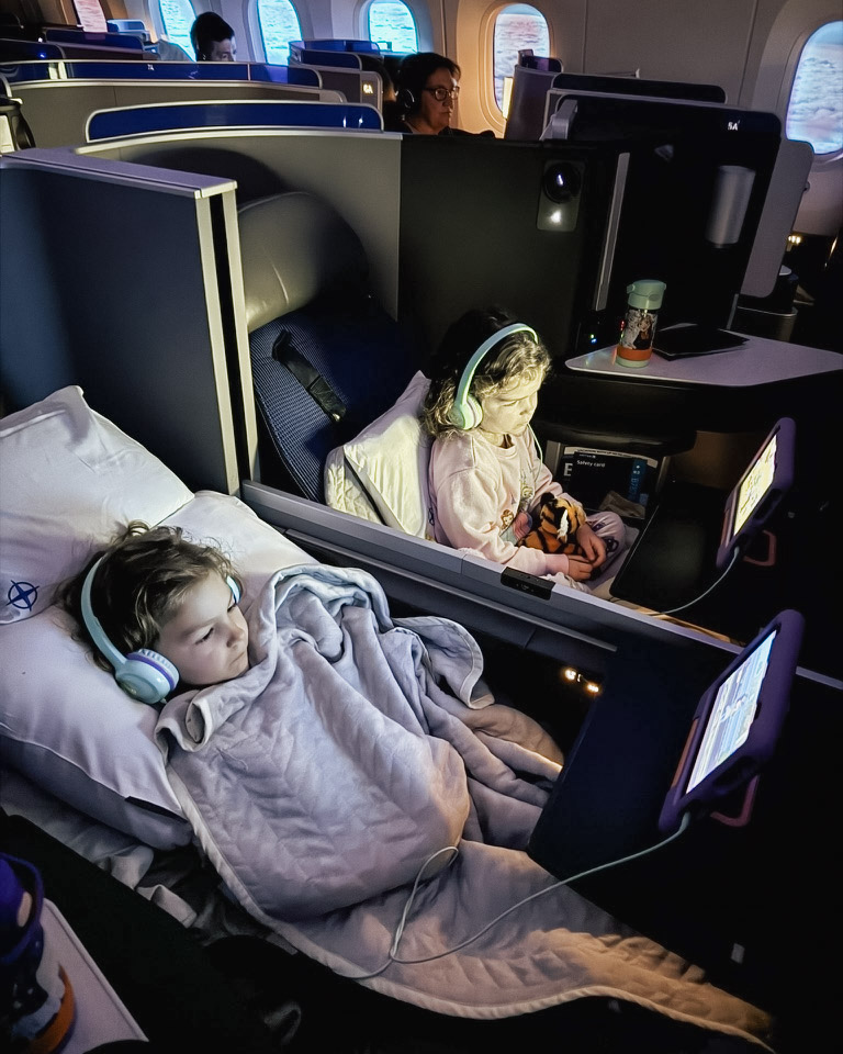 Kids flying in first class on a long-haul flight that was booked for nearly free with credit card rewards. Photo by Amy Berrian.