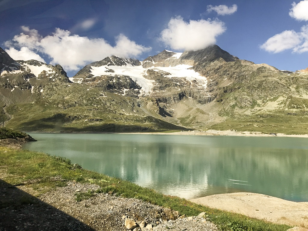 Stunning white-capped mountains, green rolling hills and teal lake water are the views from the Bernina Express in the summertime. 