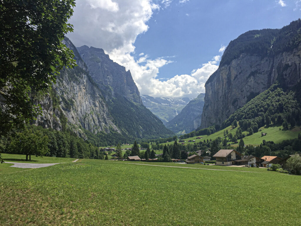 Lush green mountains with waterfalls tumbling off of them, wildflowers blooming and turquoise blue lakes and rivers flowing freely. This is the appeal of Switzerland in the summertime.