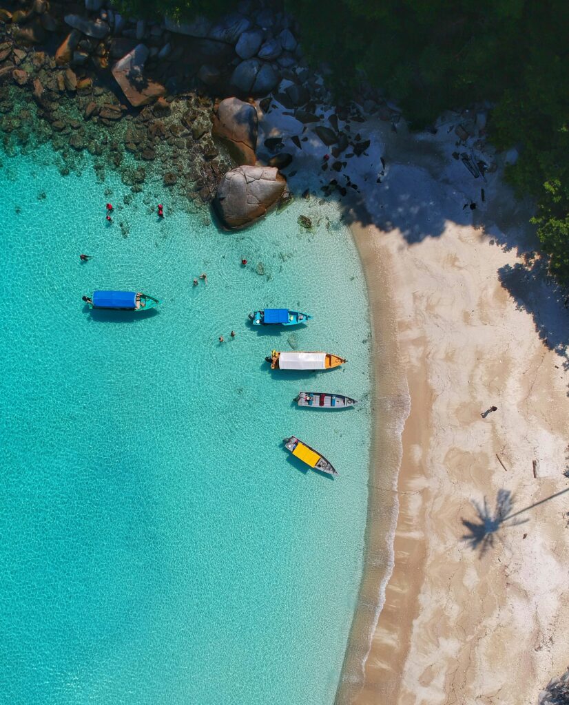 Aerial view of a tropical island paradise, showcasing dream destinations you can visit using credit card points and miles for nearly free travel. Photo by Gaddafi Rusli.