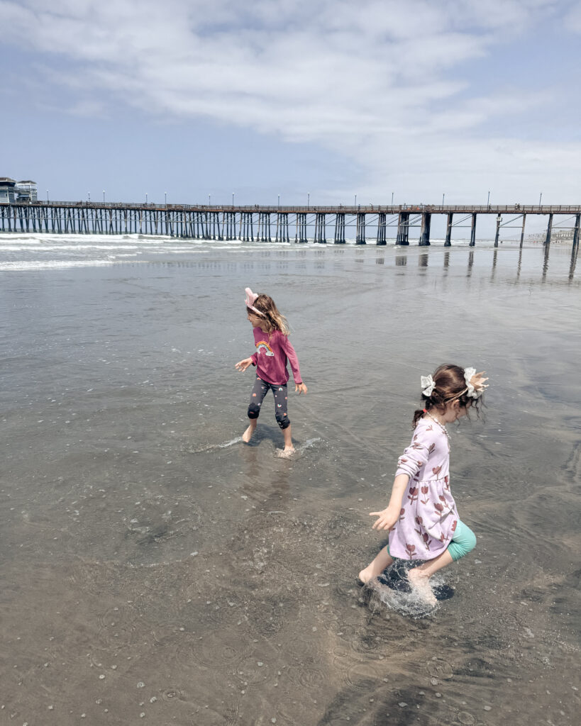 kids play on the beach in Oceanside, CA.