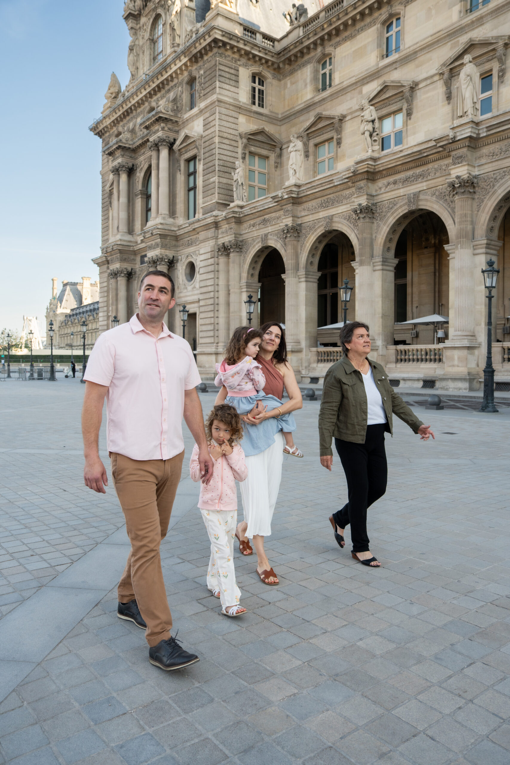 Family walking together outside the Louvre in Paris
